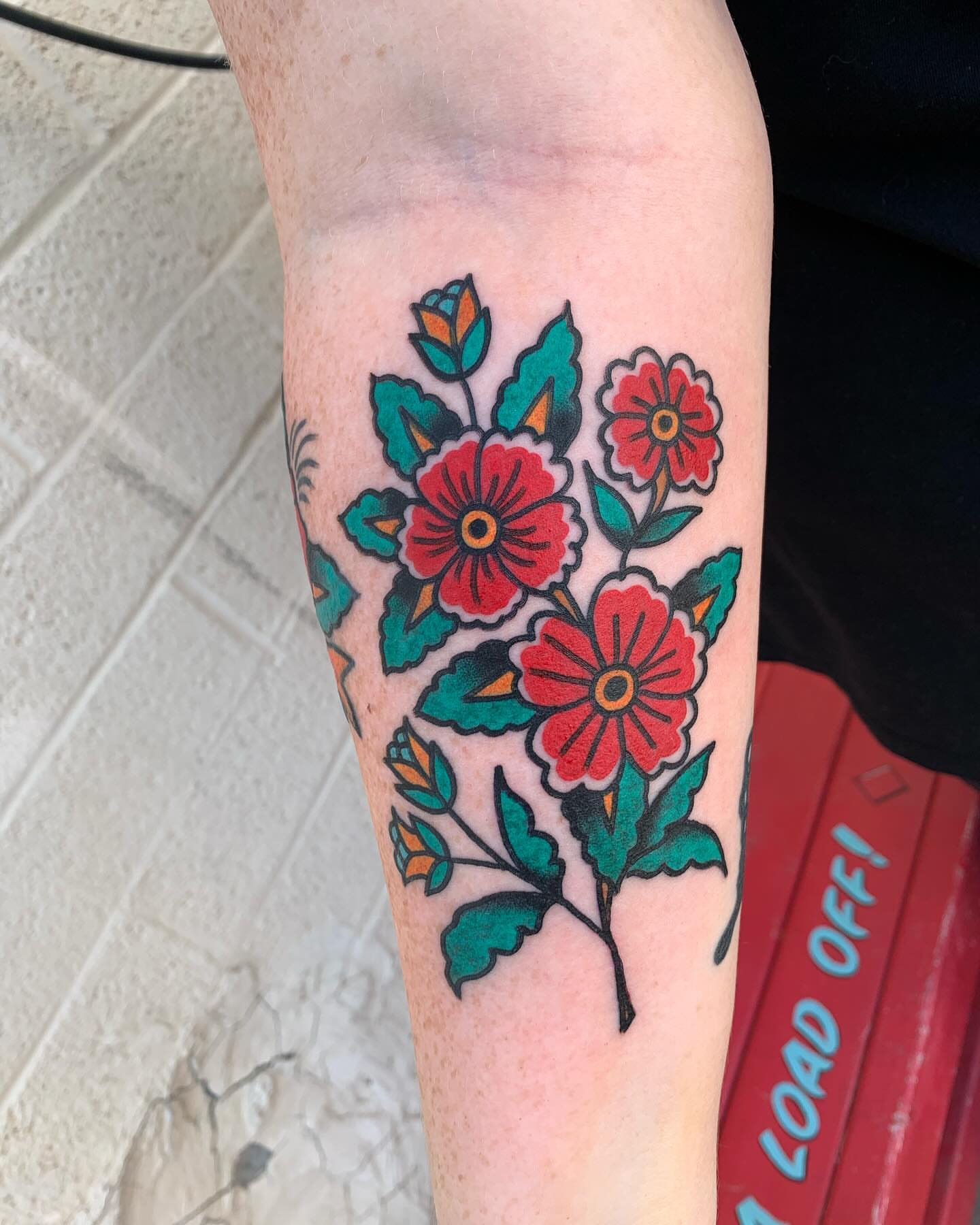Floral bouquet American traditional tattoo on the forearm by Chrissie