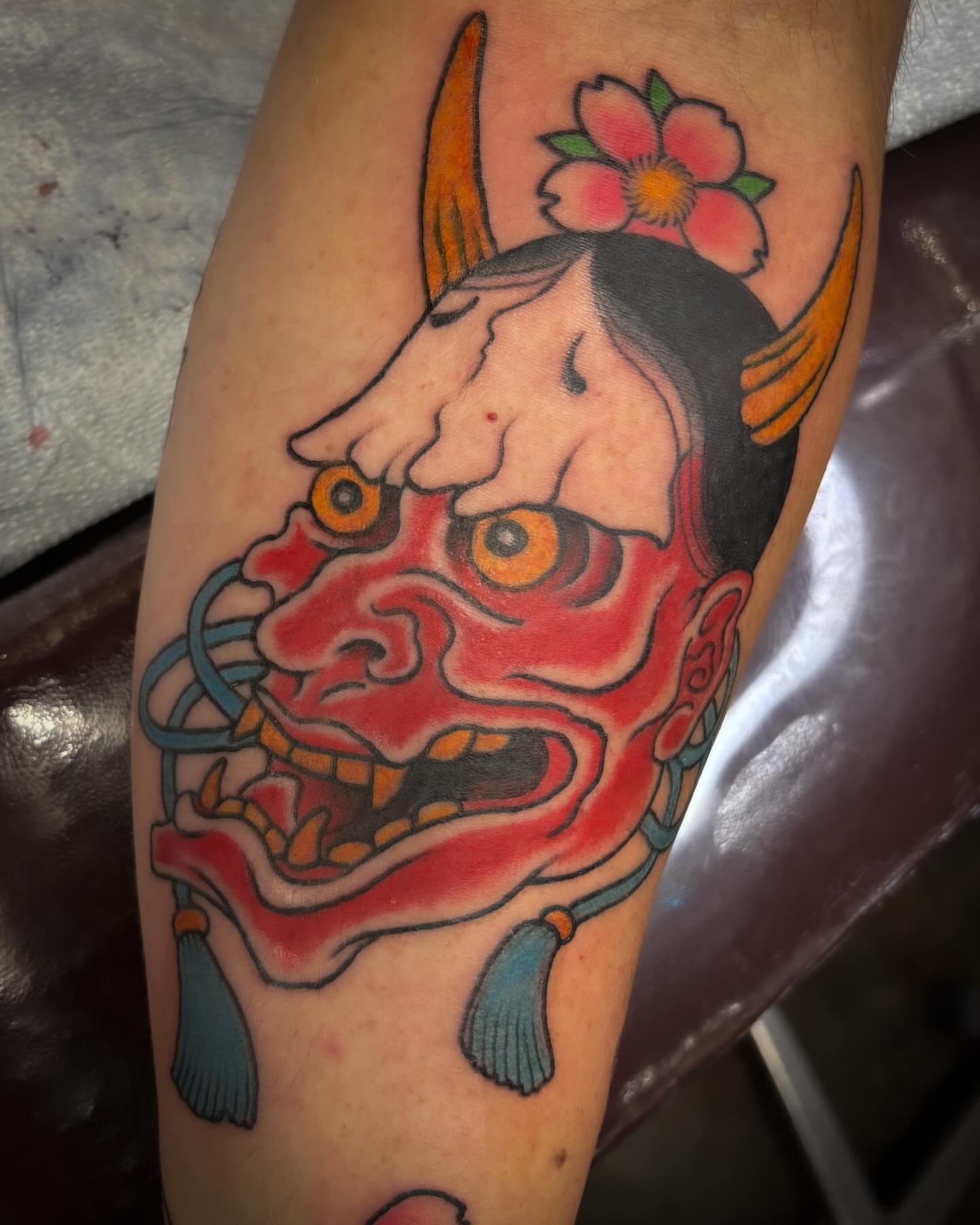Demon mask American traditional tattoo on the forearm by Adam Underwood, Minneapolis, Minnesota