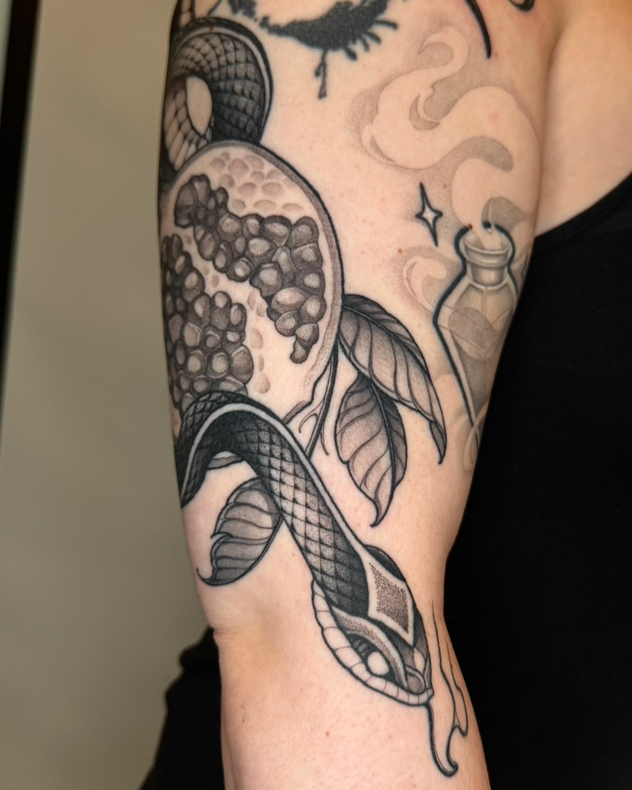 Snake and pomegranate realism tattoo on the forearm by Las Vegas Tattoo Artist