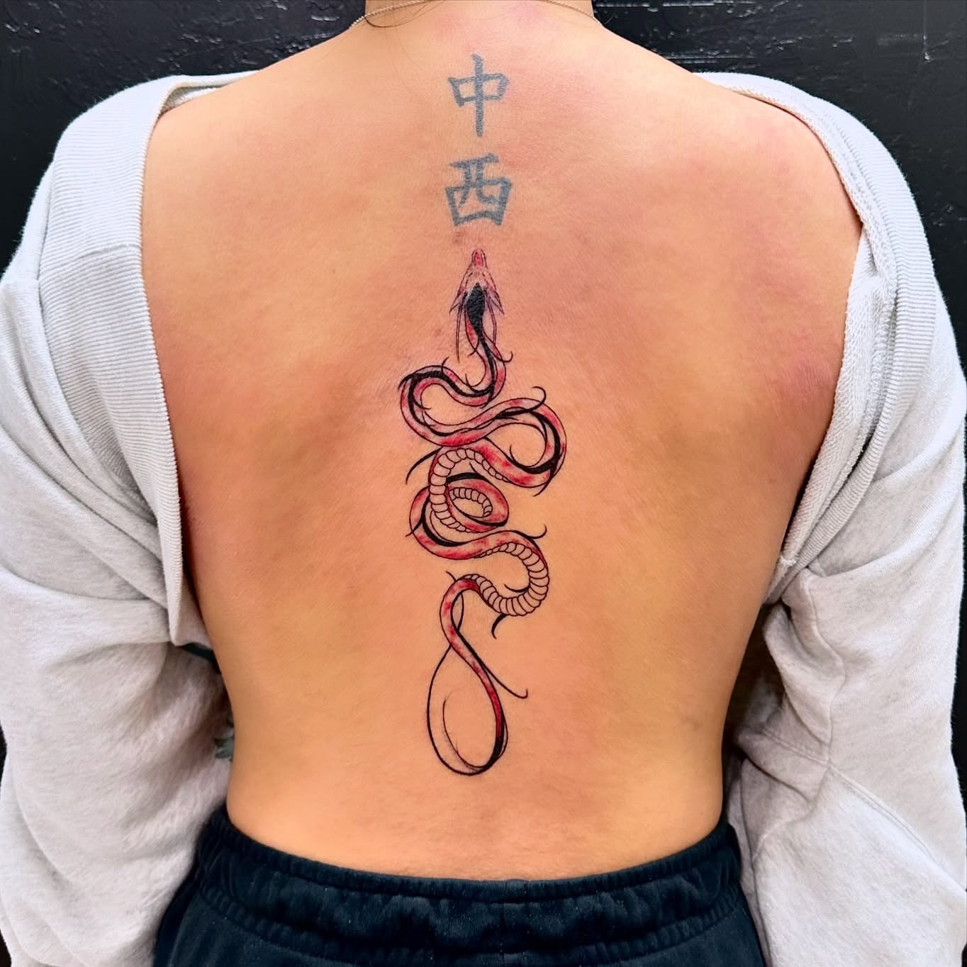 Snake new school tattoo on the back by Roxanne Ochoa