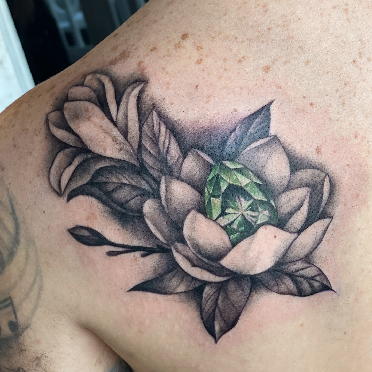 Lotus flower geometric tattoo on the shoulder by Erica Olivier