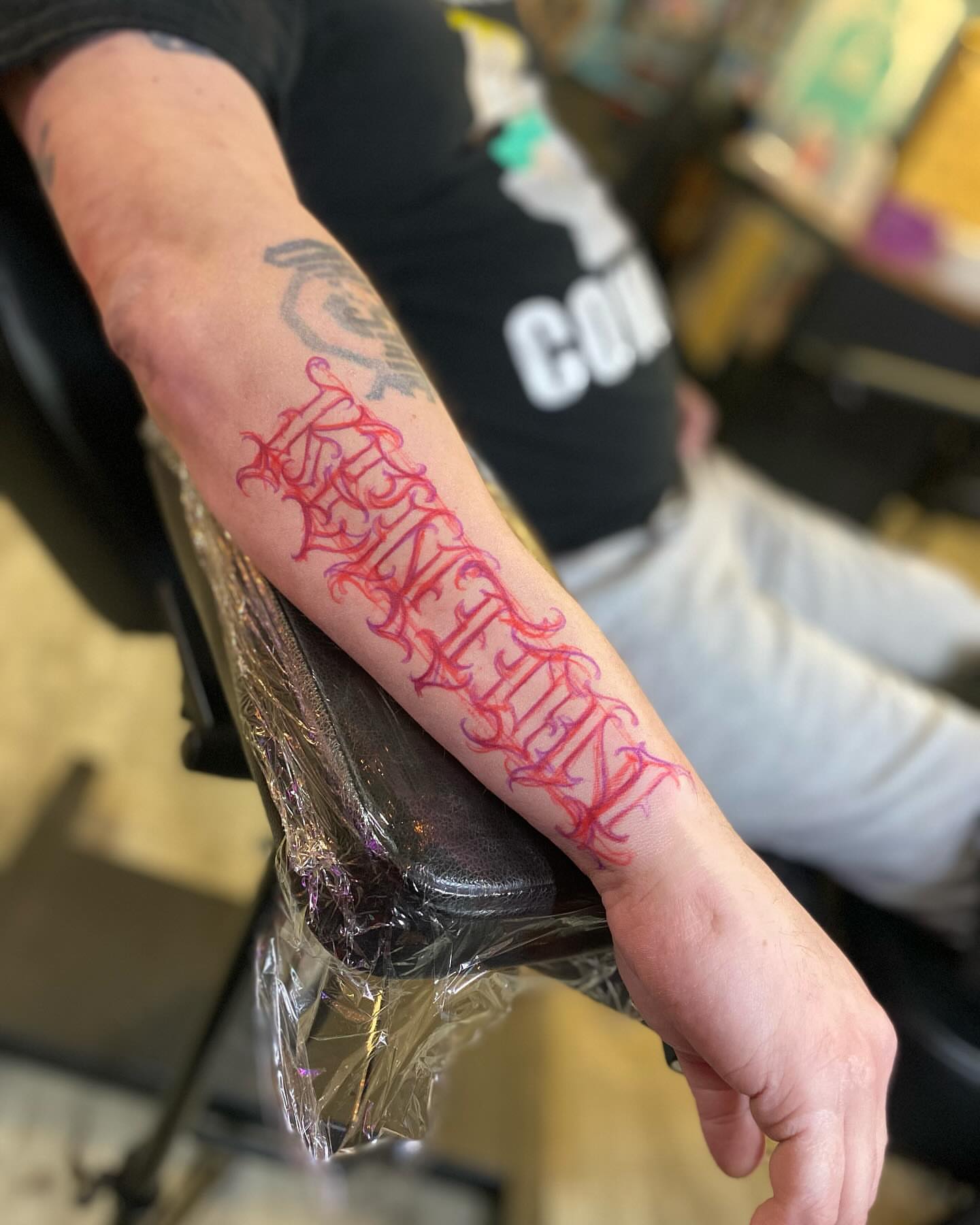 Gothic script lettering script tattoo on the forearm by Chase Skylar Clayton Ogle