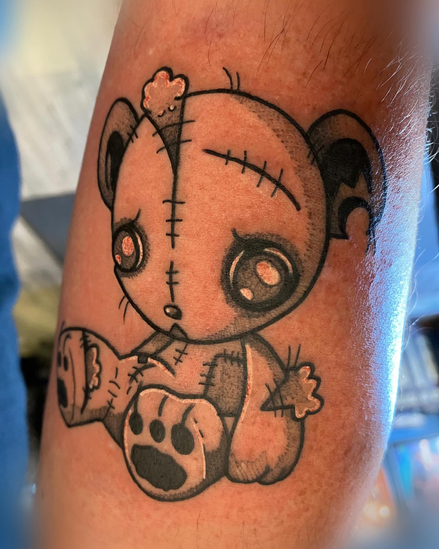 Stuffed toy black and grey tattoo on the forearm by Romans