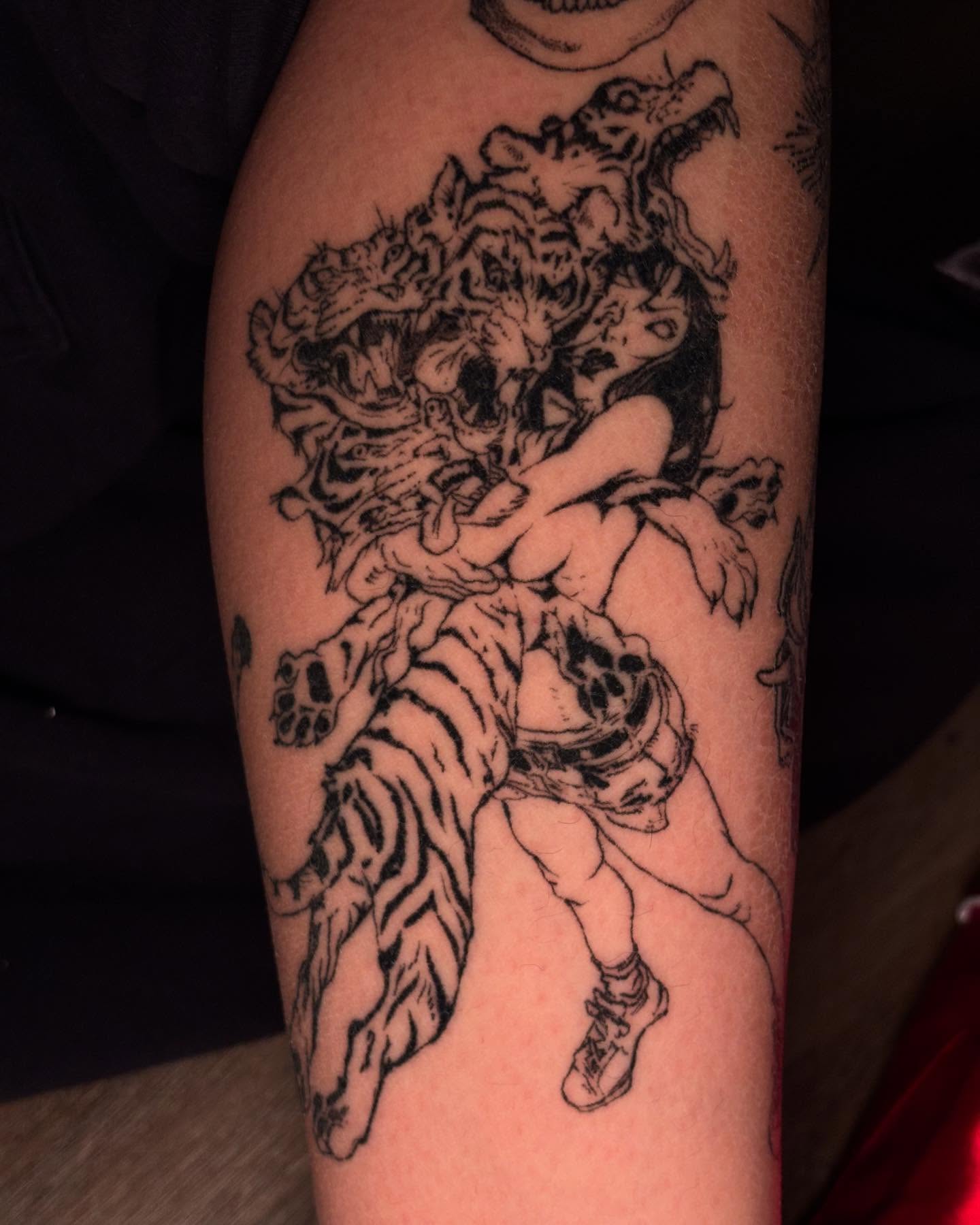Woman being attacked by tiger realism tattoo on the forearm by sanjai