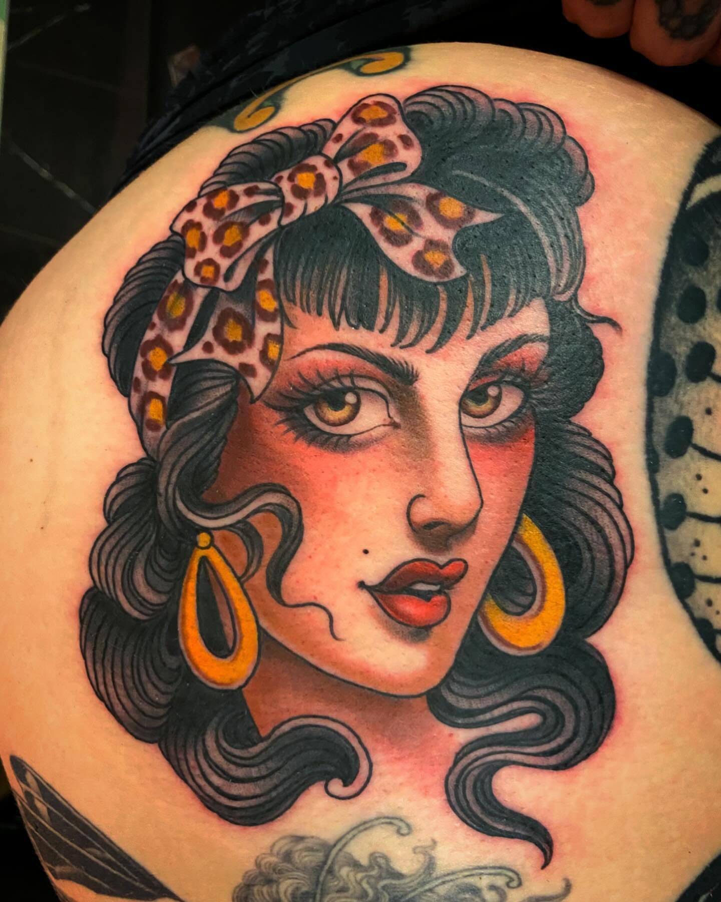 Woman with leopard print bandana American traditional tattoo on the shoulder by Adam Warmerdam, Los Angeles, California