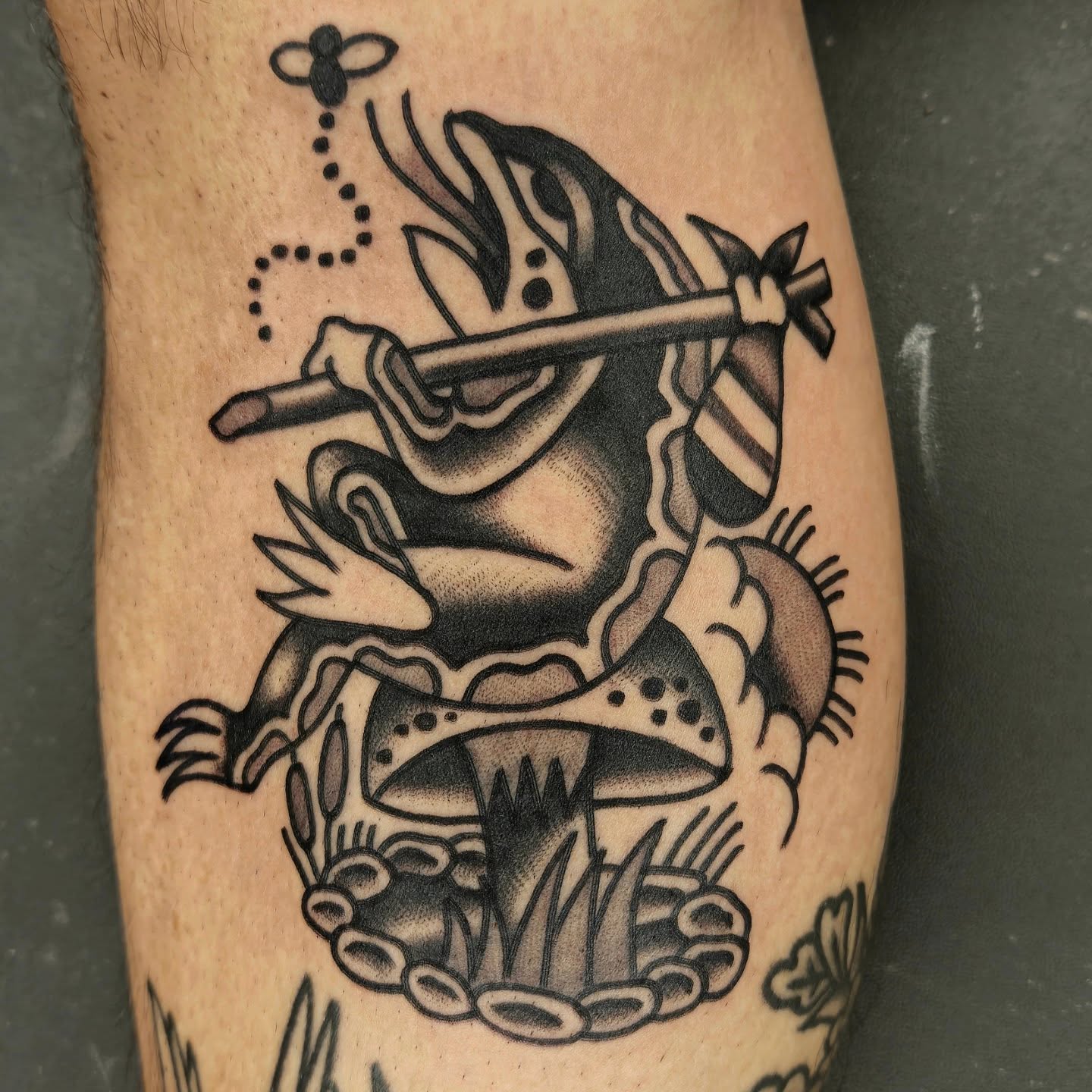 Frog playing flute American traditional tattoo on the forearm by Deke Harms, Bend, Oregon