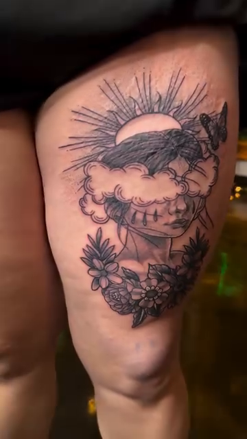 Skull with sun and flowers realism tattoo by Sergio Ramirez