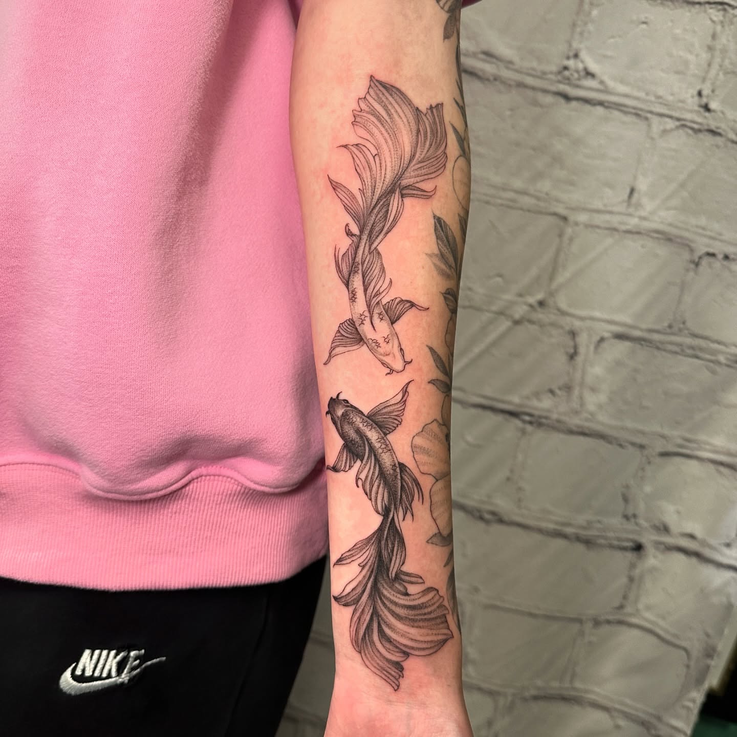 Koi fish black and grey tattoo on the forearm by Stephen Hansen