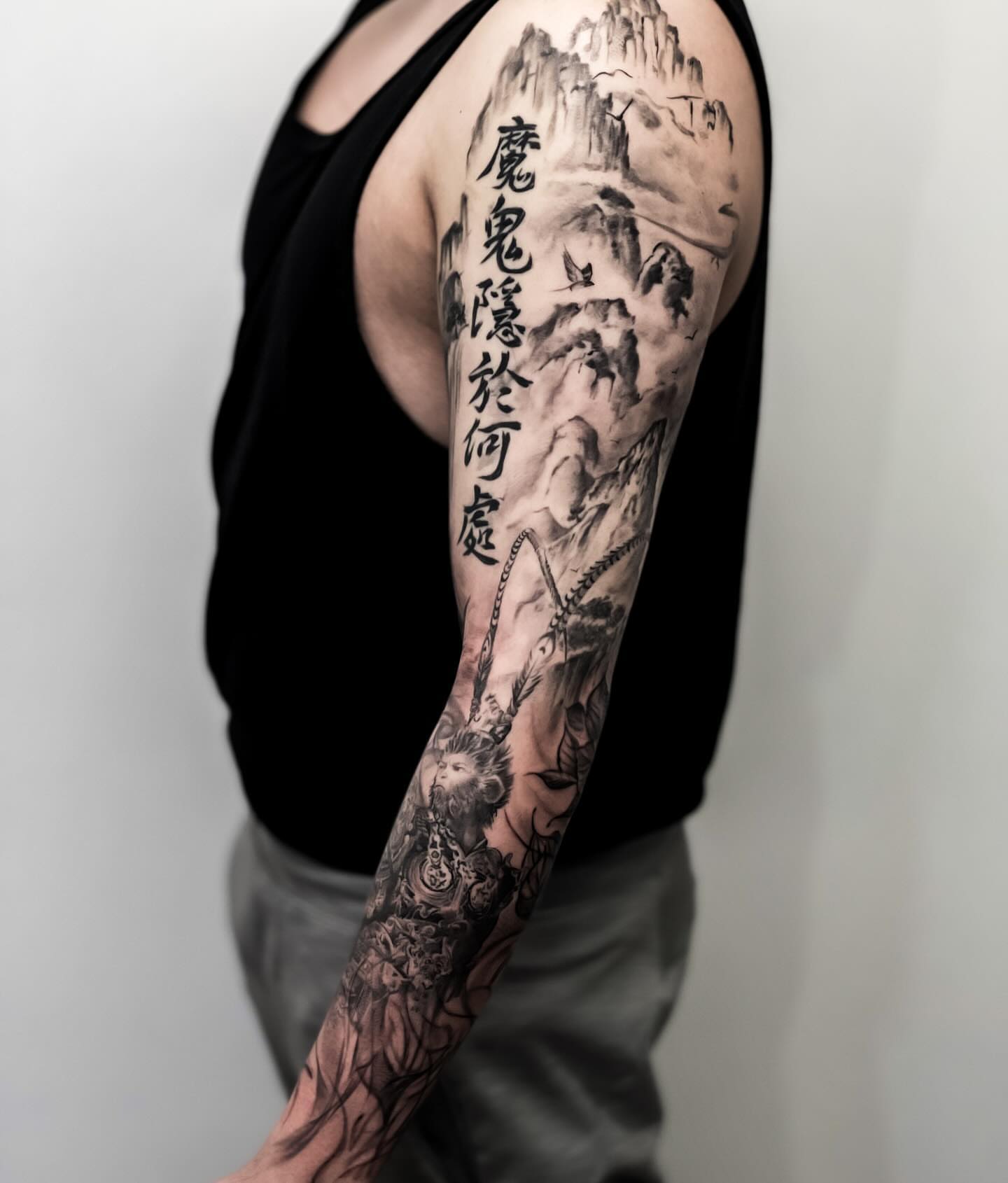 Mountain landscape realism tattoo on the upper arm by Banky