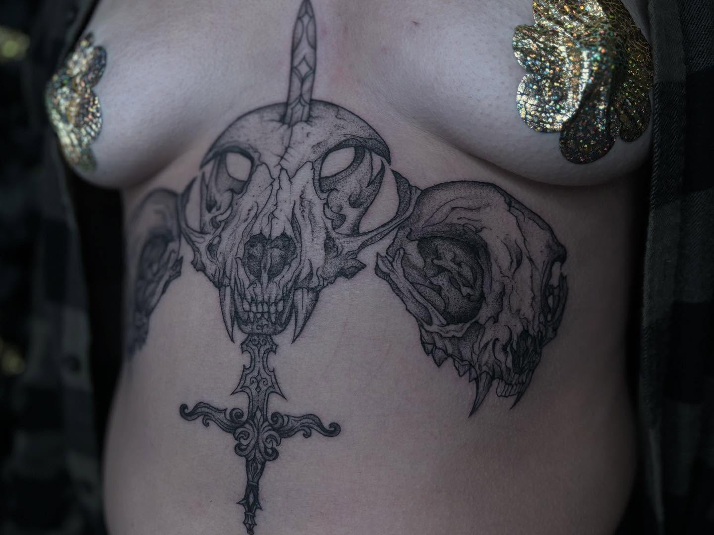 Skulls and cross realism tattoo on the chest by Ivanna
