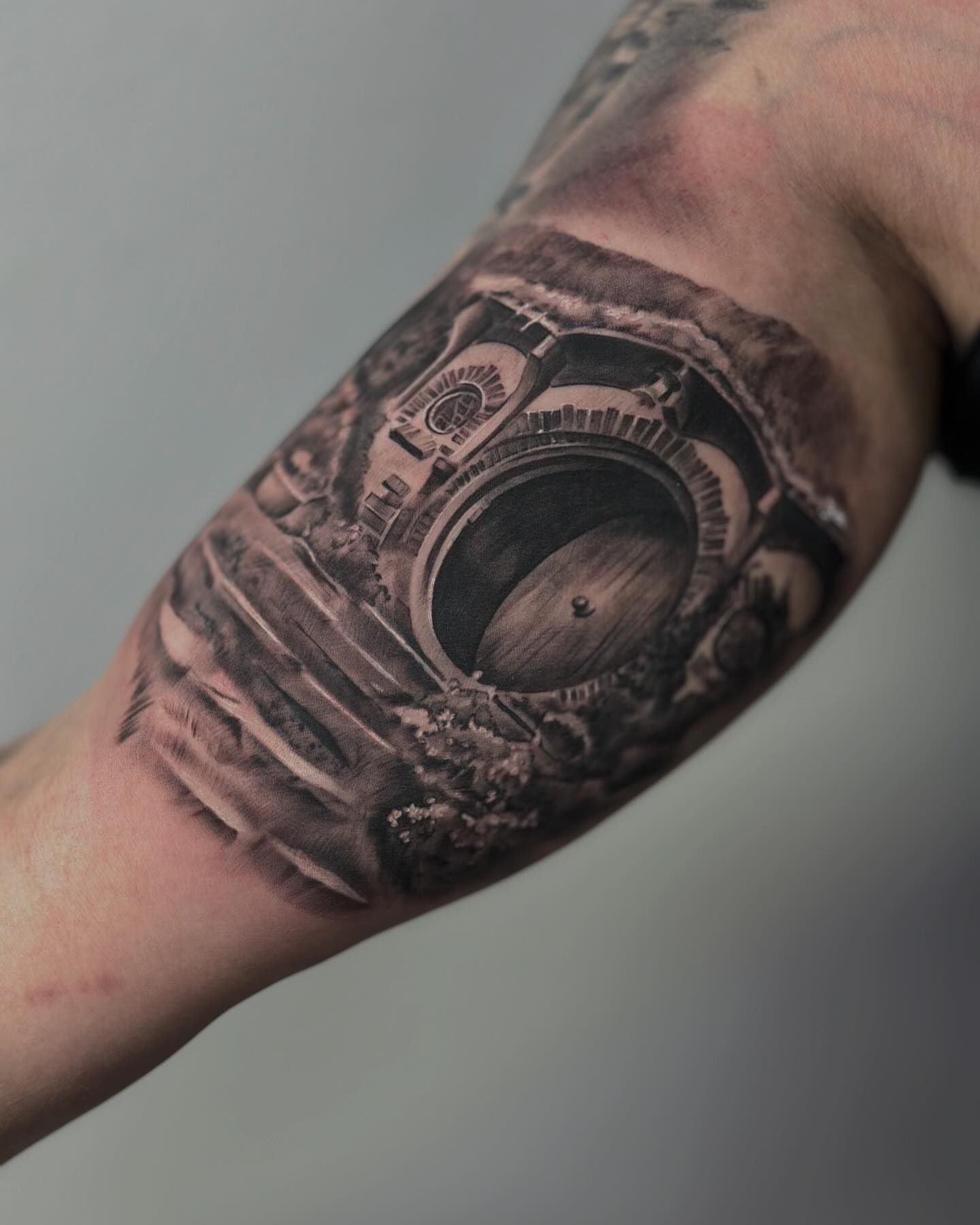 Camera realism tattoo on the forearm by Aaron Watson