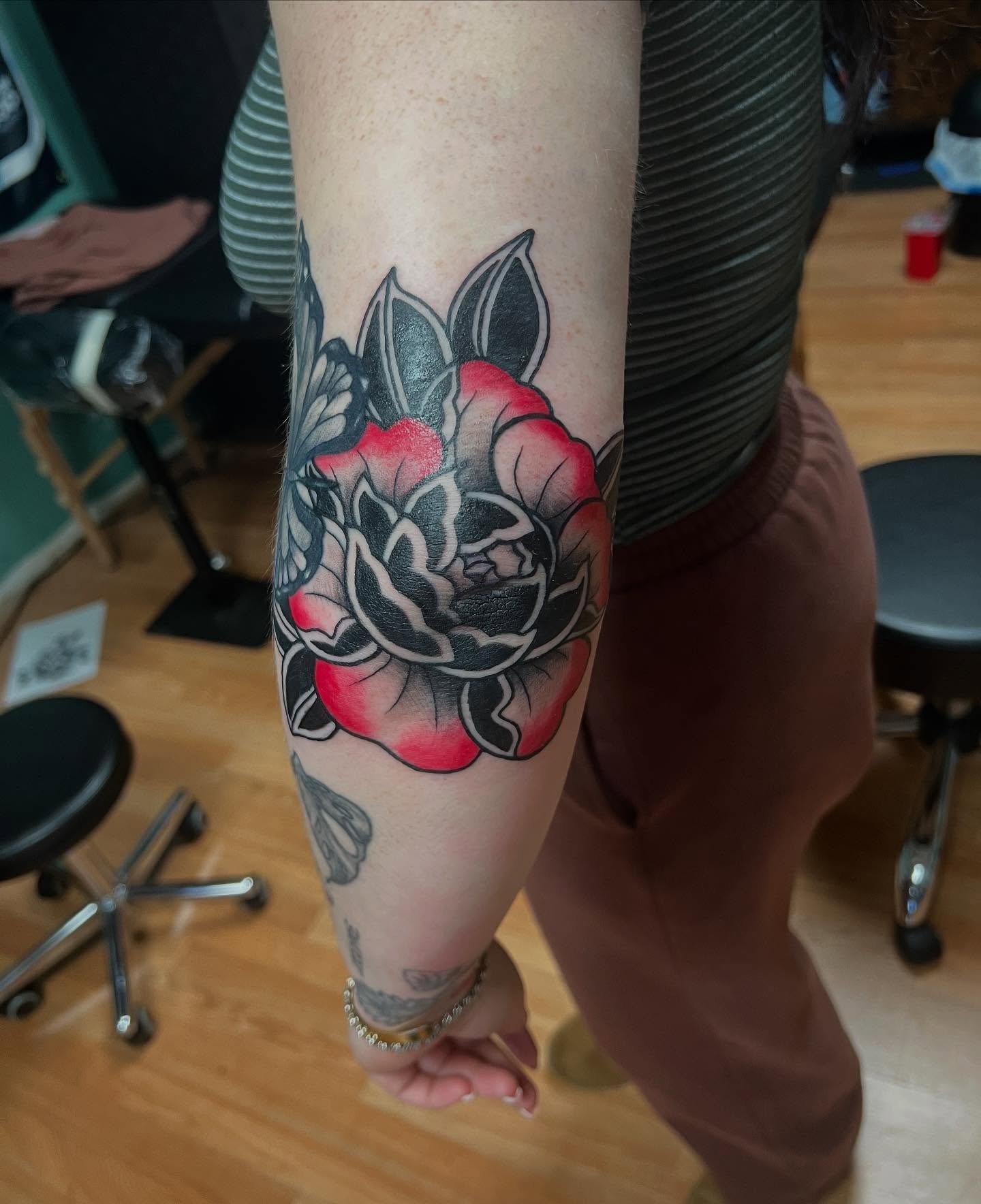 Rose American traditional tattoo on the forearm by Katie Sayre