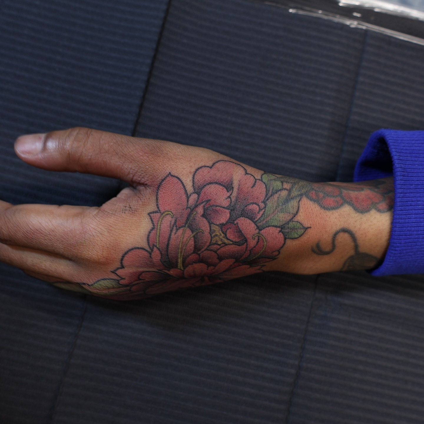 Floral bouquet American traditional tattoo on the hand by mssinderella