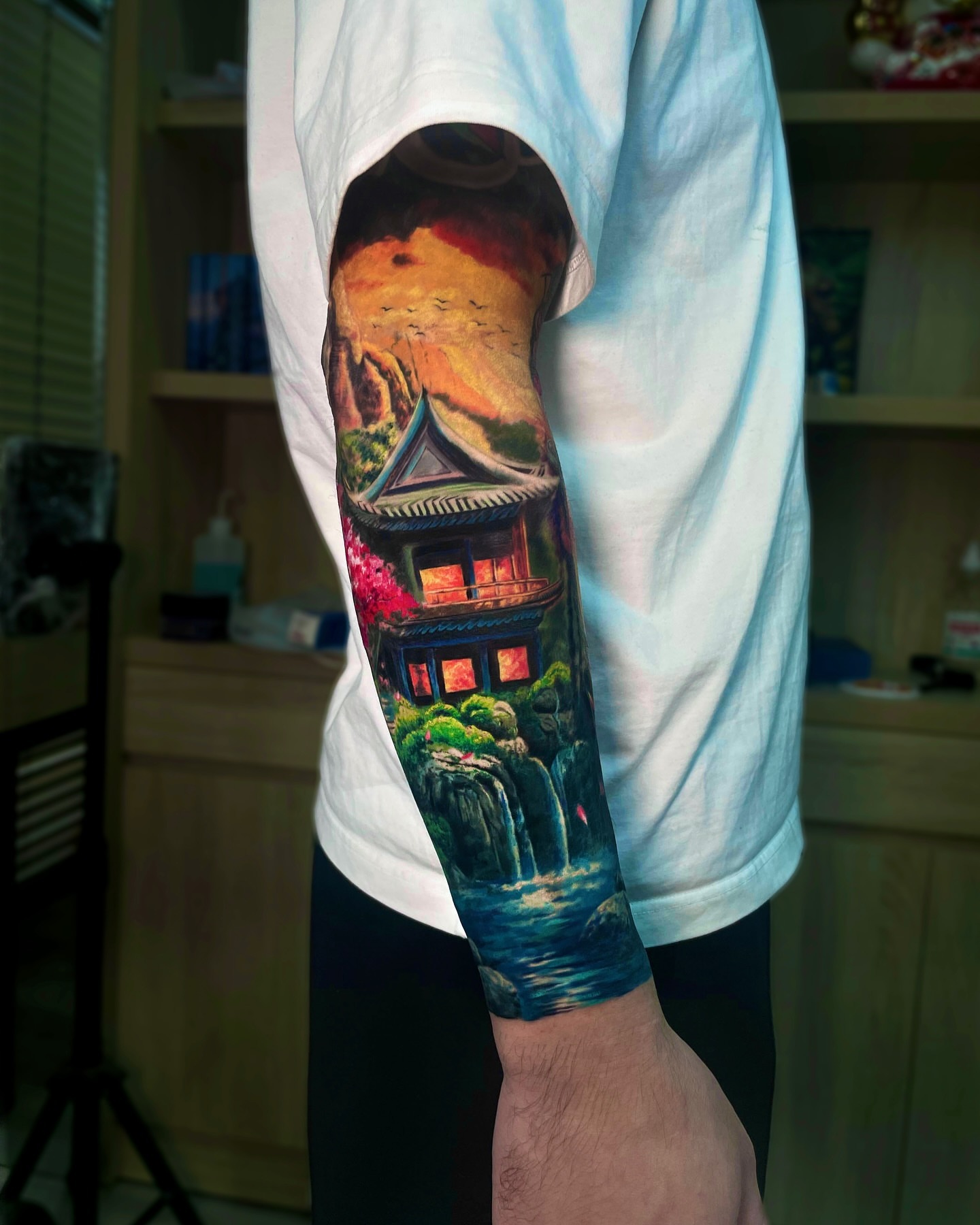 Oriental house and waterfall realism tattoo on the forearm by Bình Nguyễn