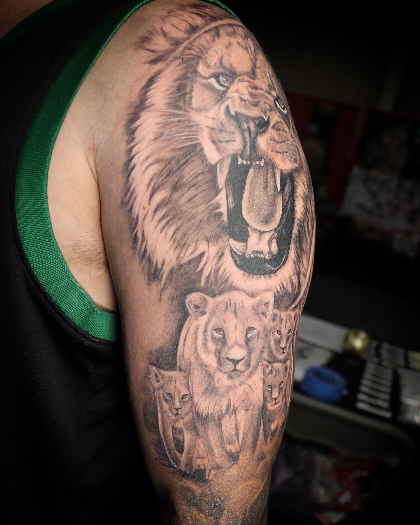 Lion family realism tattoo on the upper arm by Romi Utah Tattoo