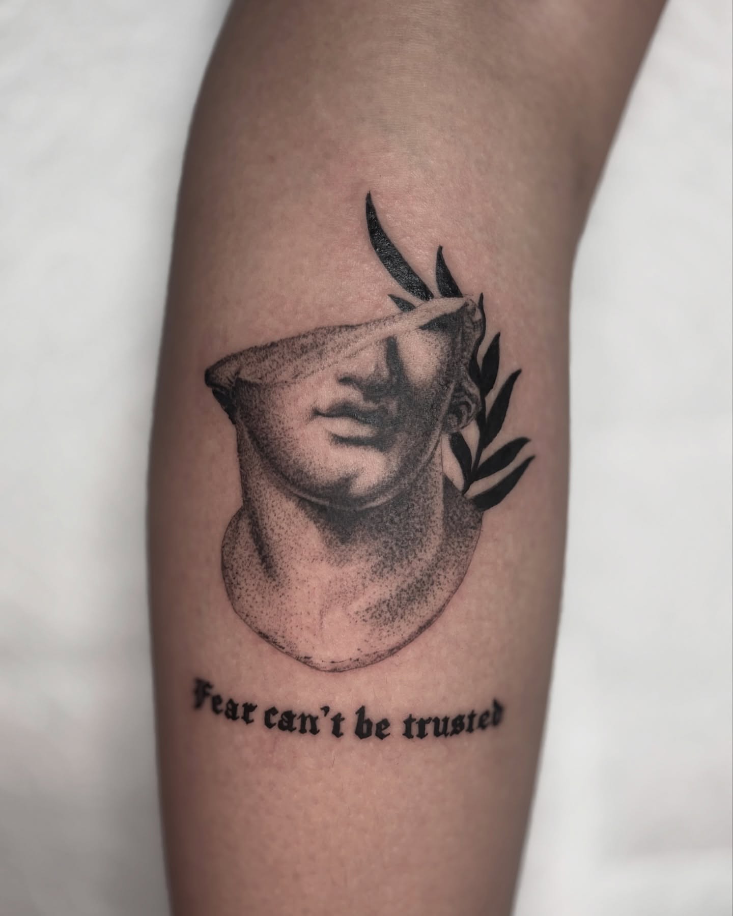 Blindfolded bust dotwork tattoo on the forearm by Bryan