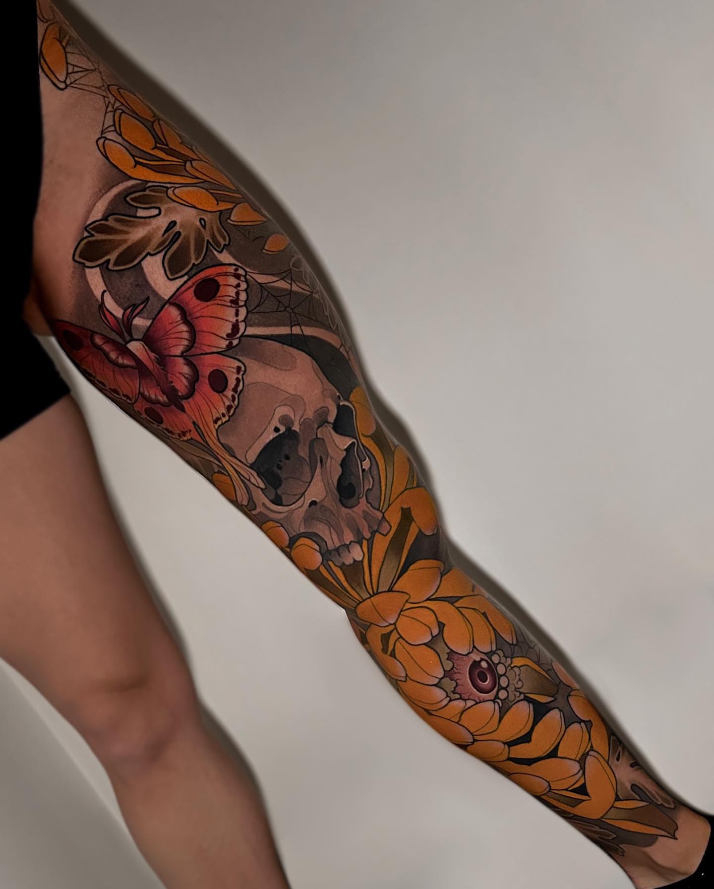 Skull and flowers American traditional tattoo on the forearm by Levi Murphy