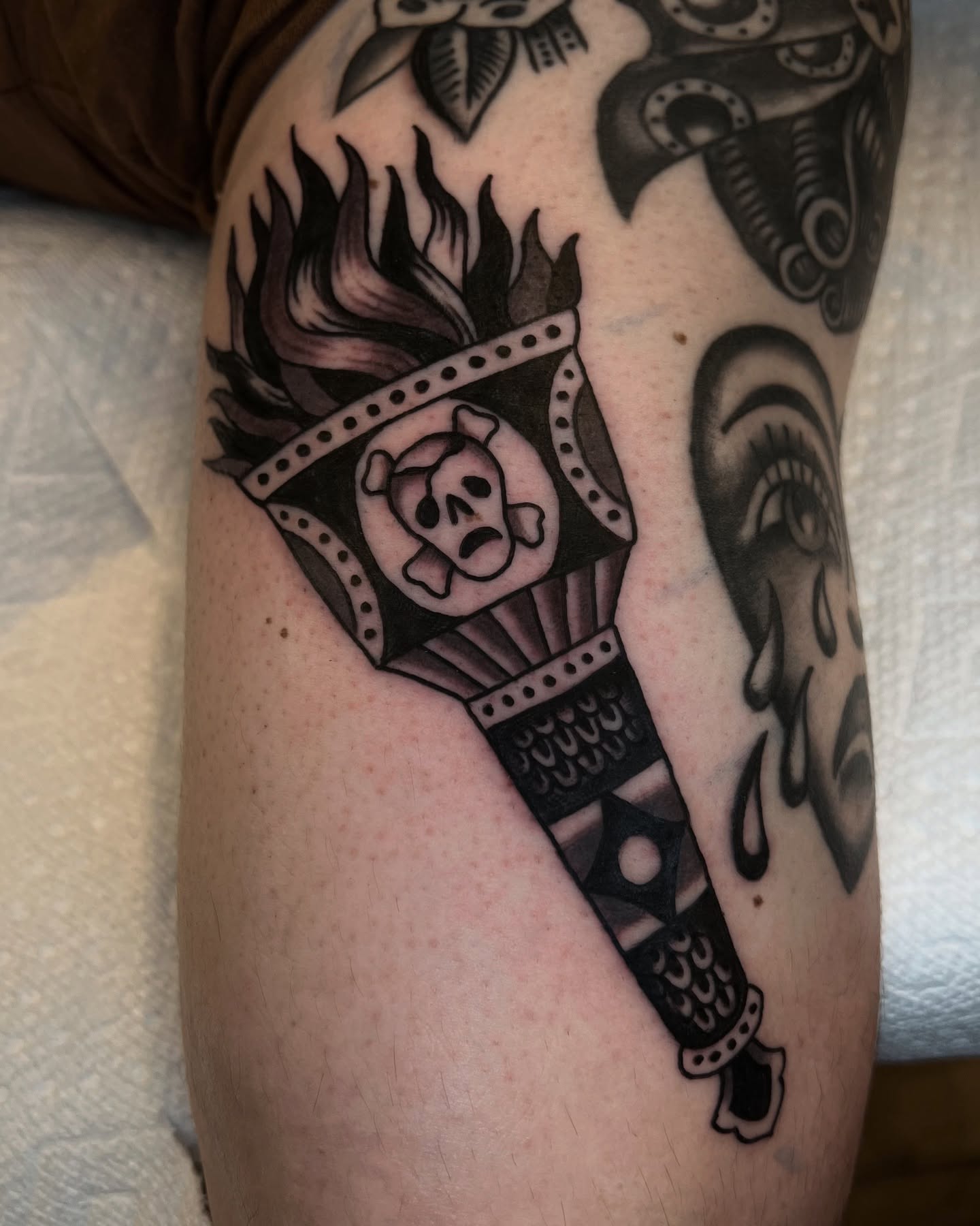 Flame and skull American traditional tattoo on the forearm by Syd Sayyah