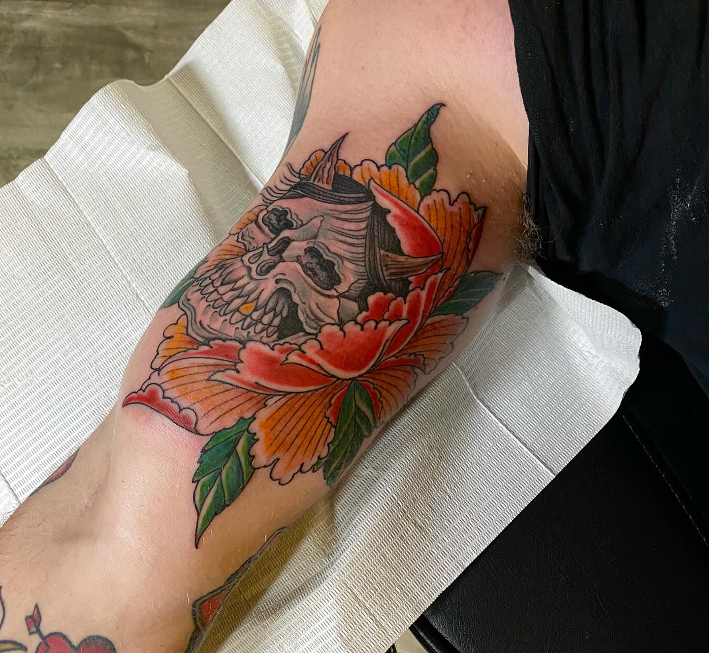 Skull and flowers American traditional tattoo on the forearm by Chase Skylar Clayton Ogle