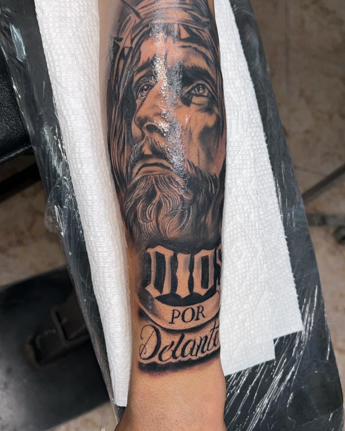 Religious figure realism tattoo on the forearm by Bryant Ramirez