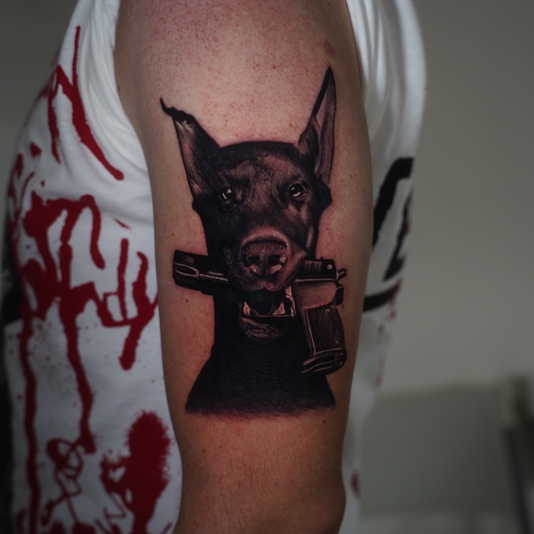 Dog with guns realism tattoo on the forearm by ๐ธ๐๐๐.๐ฎ๐, Los Angeles, California