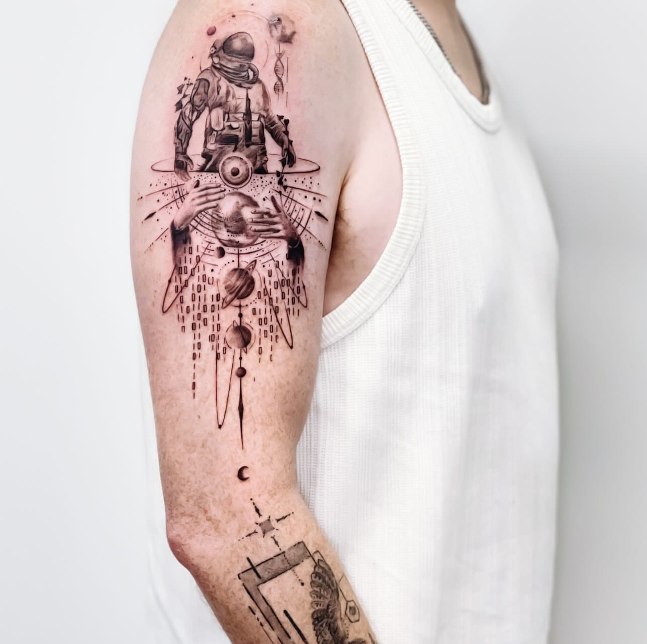 Astronaut and celestial bodies dotwork tattoo on the forearm by Banky