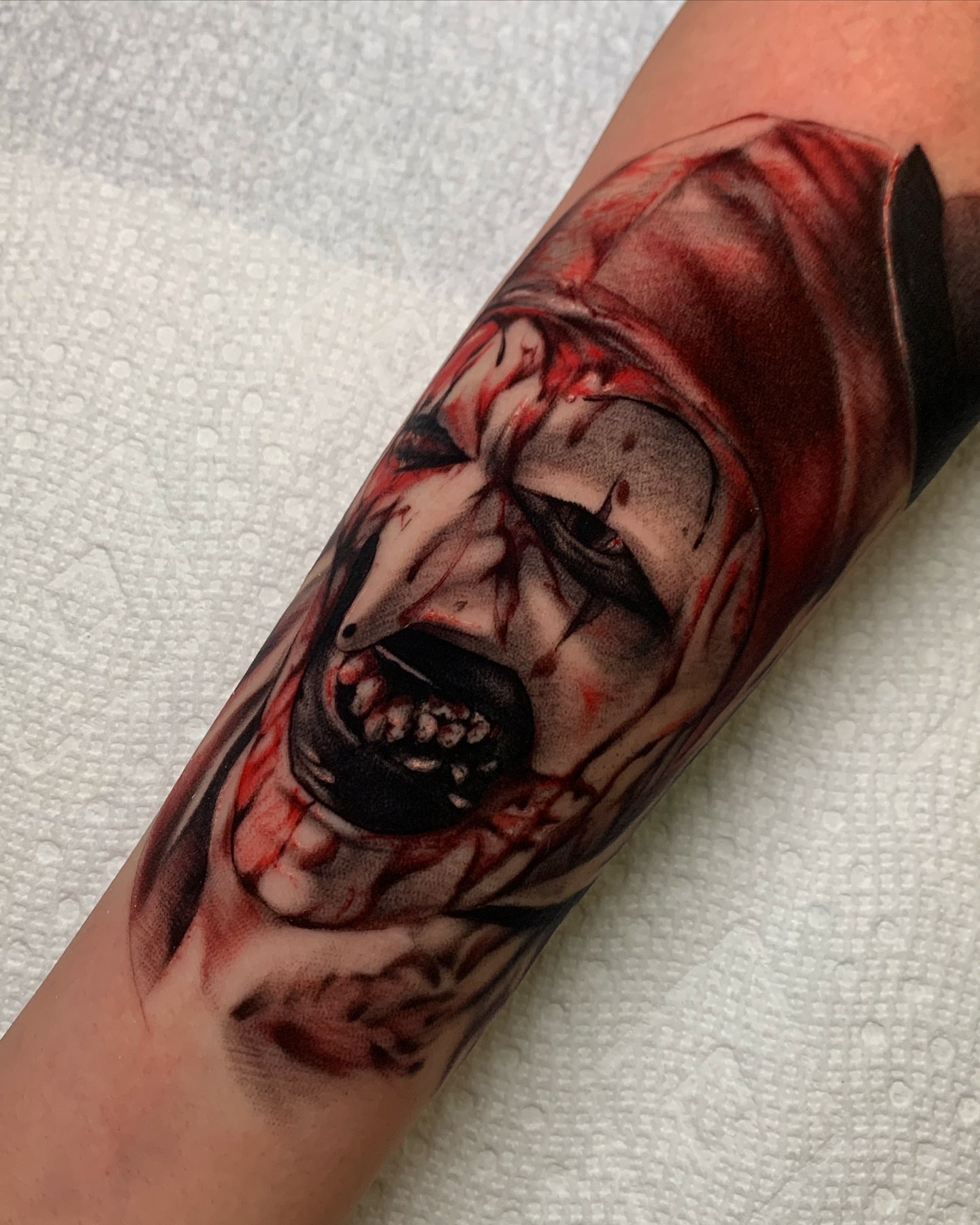 Horror creature dark realism tattoo on the forearm by Rory Somerville