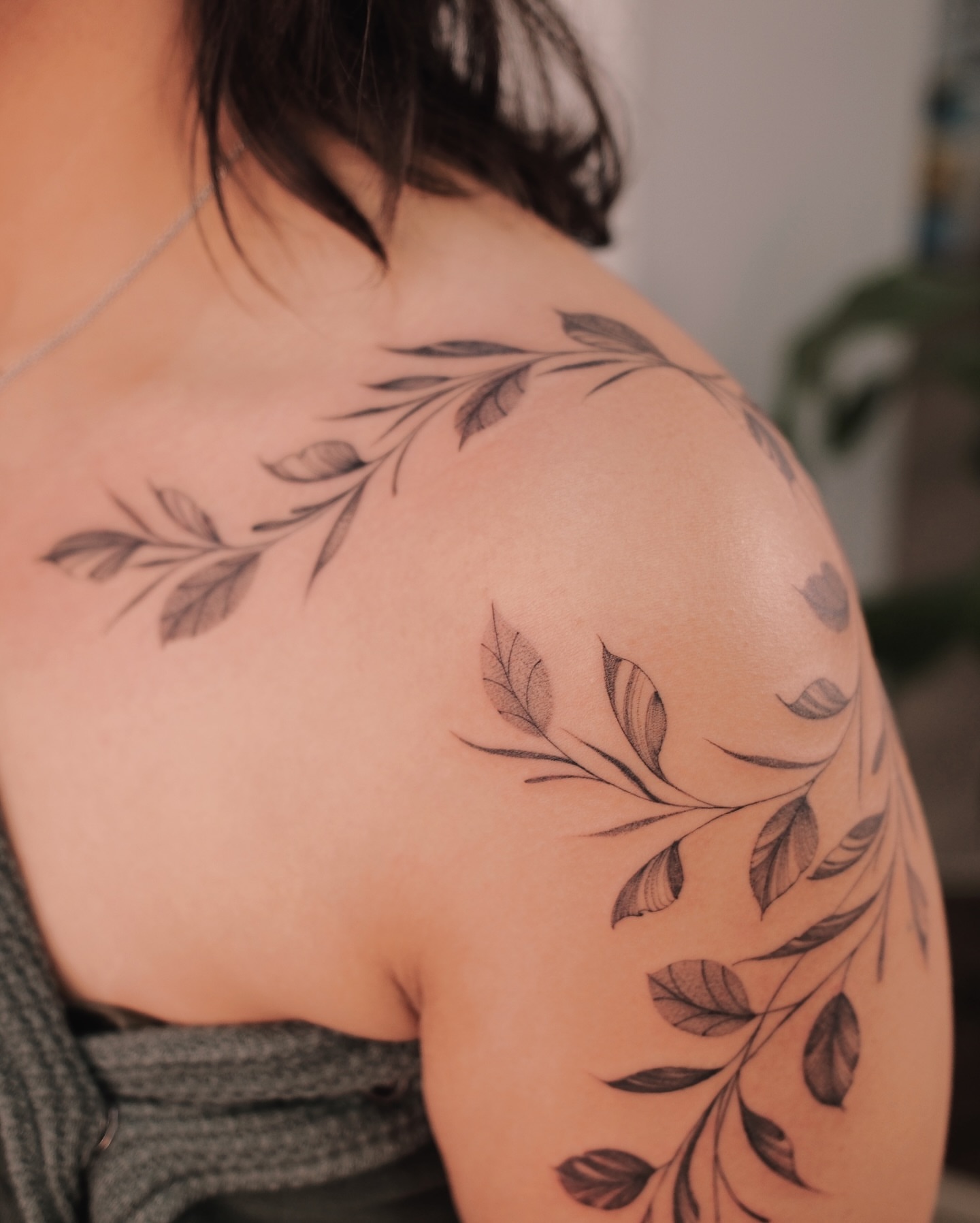 Leafy branches black and grey tattoo on the shoulder by Sky Ng Tattoo Artist in Katy