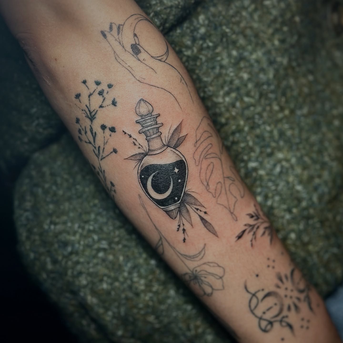 Moon bottle black and grey tattoo on the forearm by Sabrina, Harrison, New Jersey