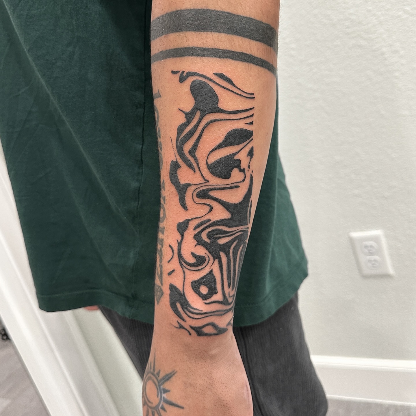 Abstract design tribal tattoo on the forearm by Alex