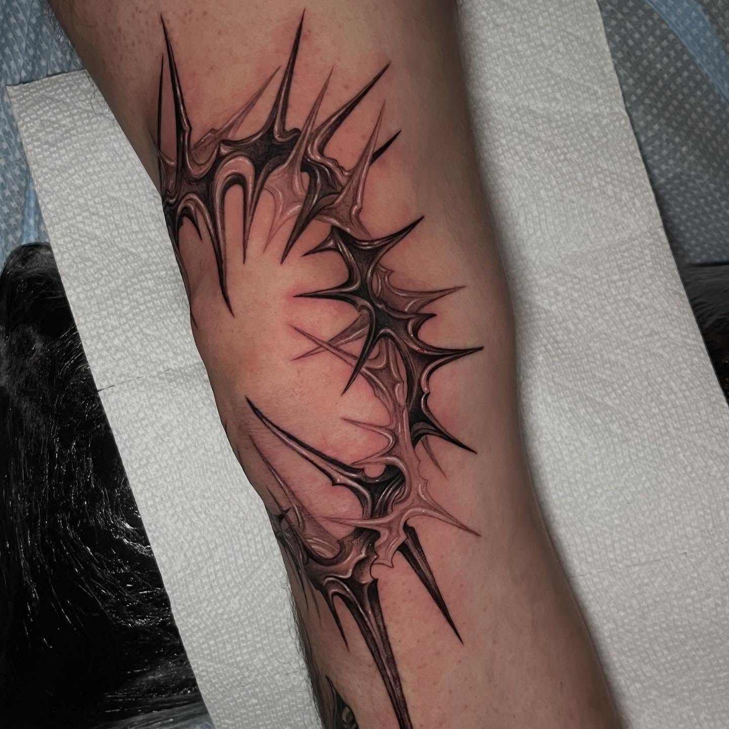 Spiky crown black and grey tattoo on the forearm by Single Needle ๐ชฉ