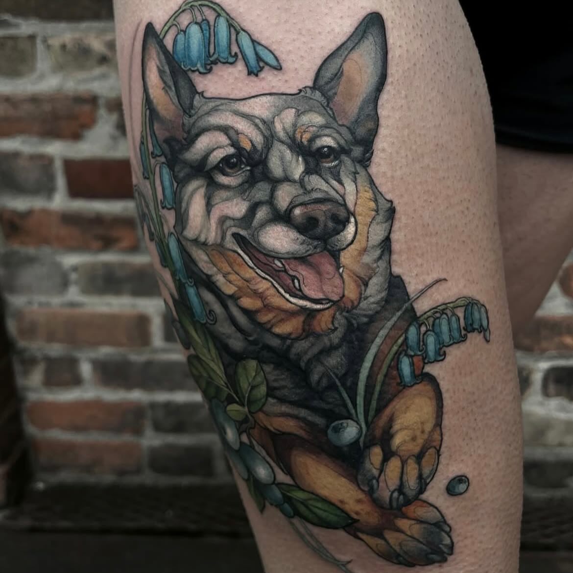 Dog with flowers realism tattoo on the thigh by β₯πΈππͺπ€π€π ππβπππβ₯