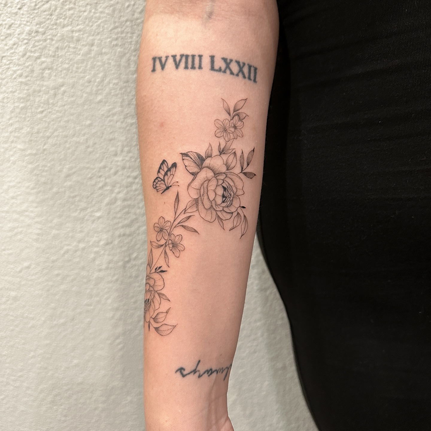 Floral arrangement black and grey tattoo on the forearm by Alex