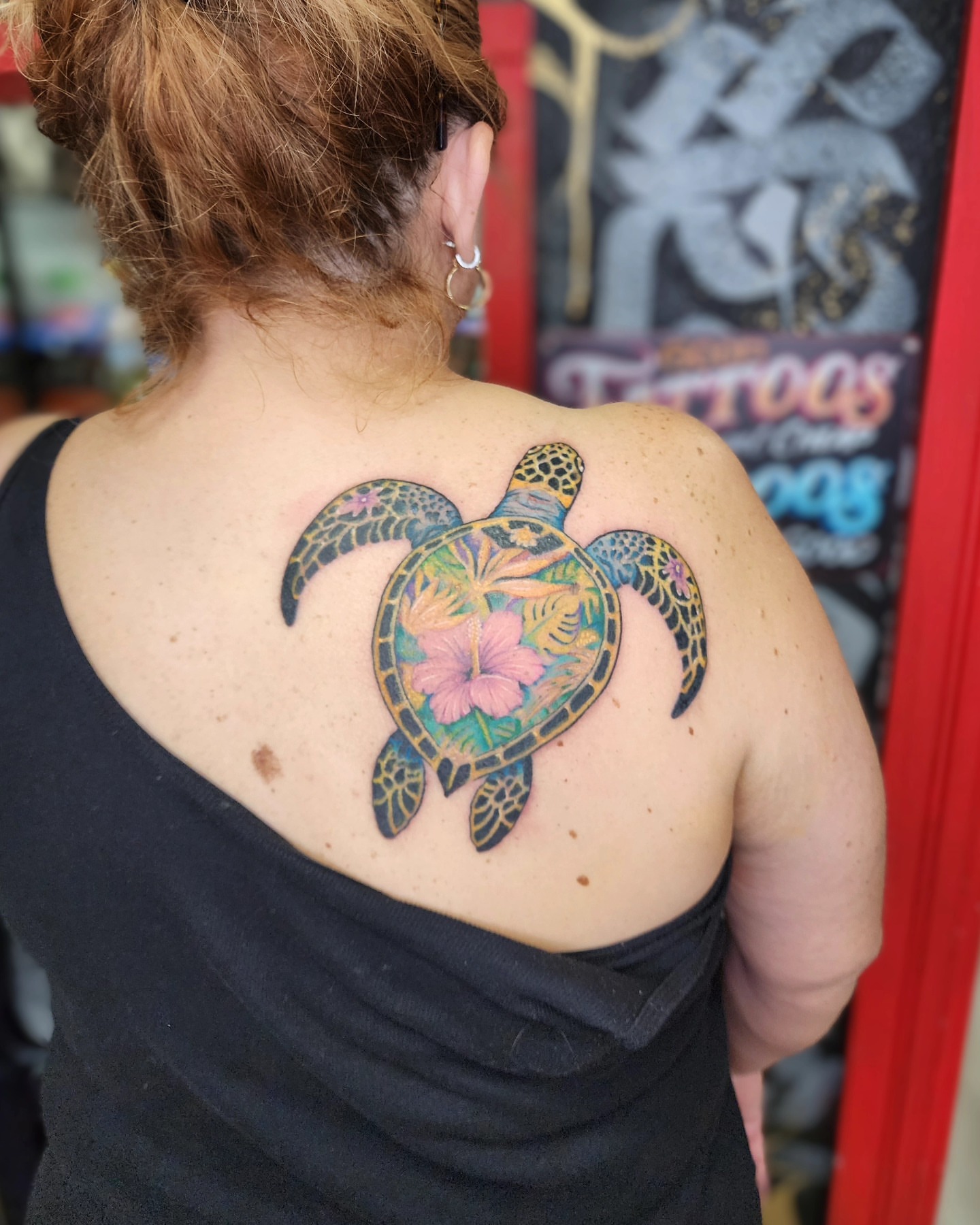Sea turtle with flowers new school tattoo on the back by Bry True