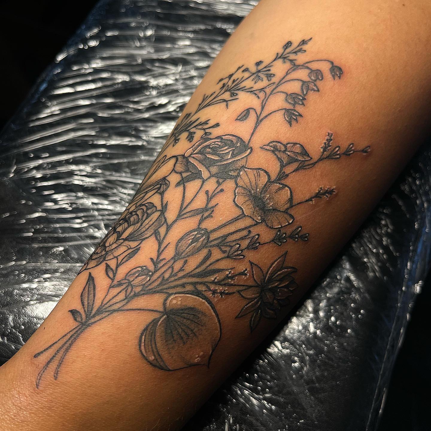 Floral arrangement black and grey tattoo on the forearm by π΅πππππ