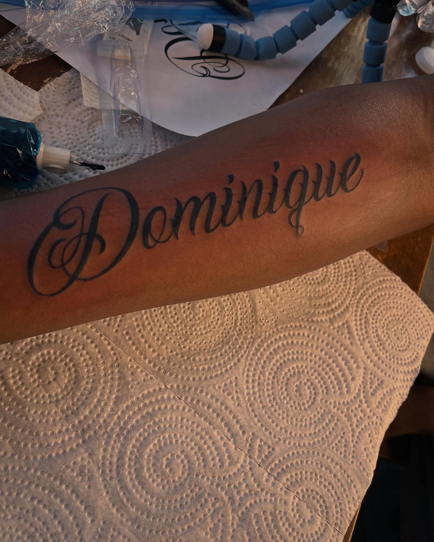 Dominique lettering script tattoo on the forearm by Bris