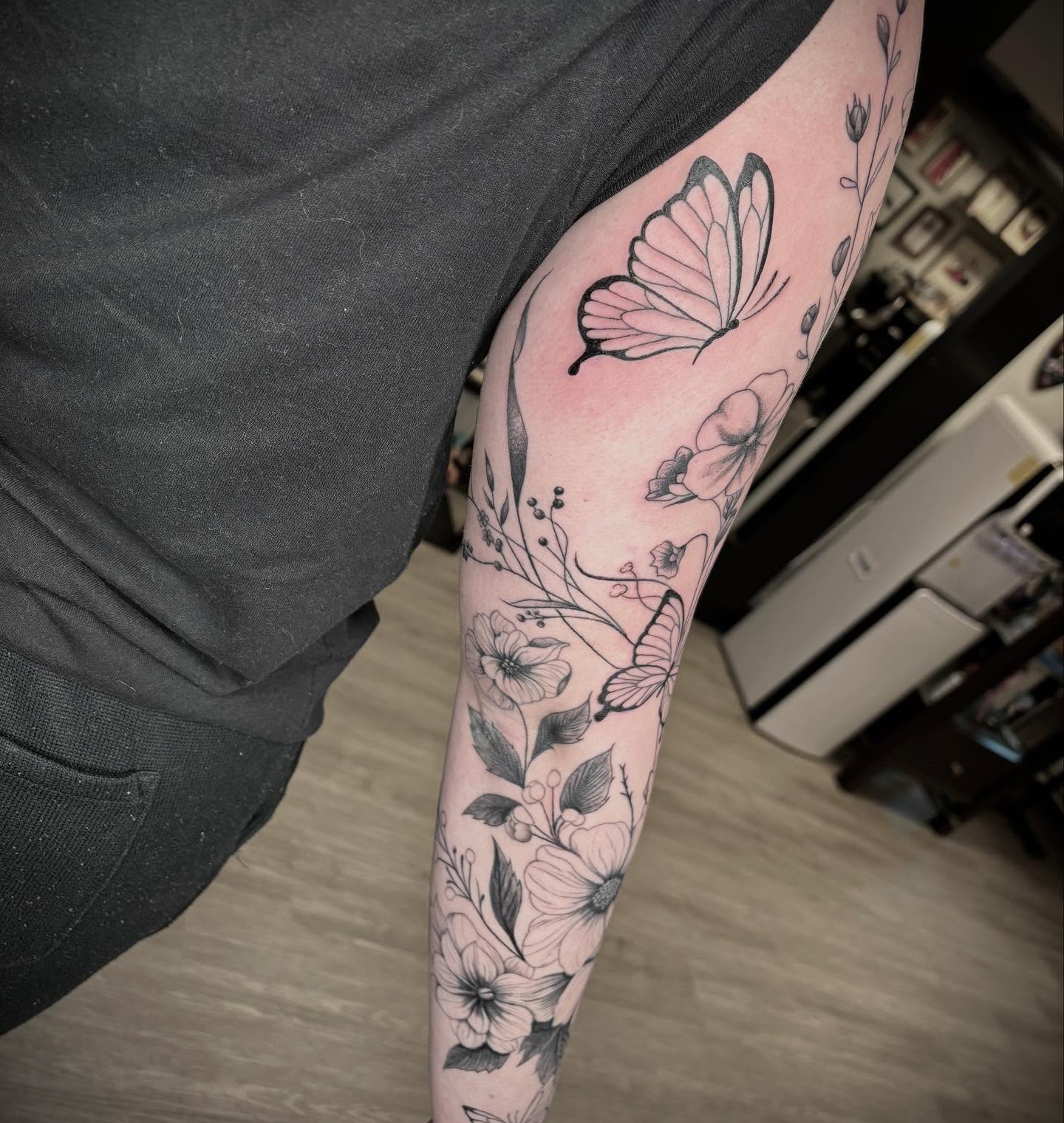 Butterflies and flowers black and grey tattoo on the forearm by Amber N