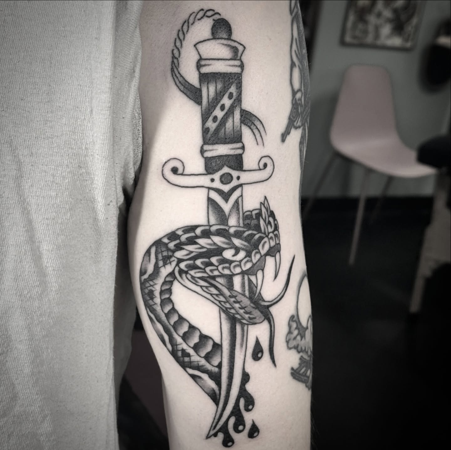 Sword and snake black and grey tattoo on the forearm by Sean McMahon