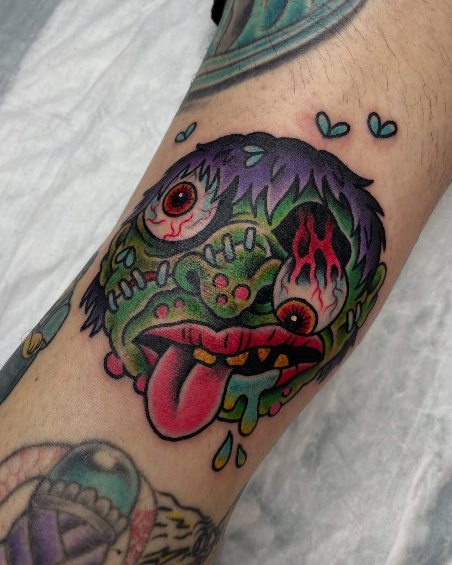 Zombie head American traditional tattoo on the forearm by Tom Taylor, Philadelphia, Pennsylvania