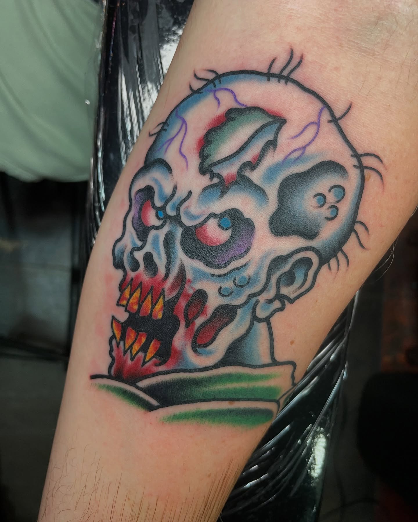 Skull American traditional tattoo on the forearm by Tom Taylor, Philadelphia, Pennsylvania
