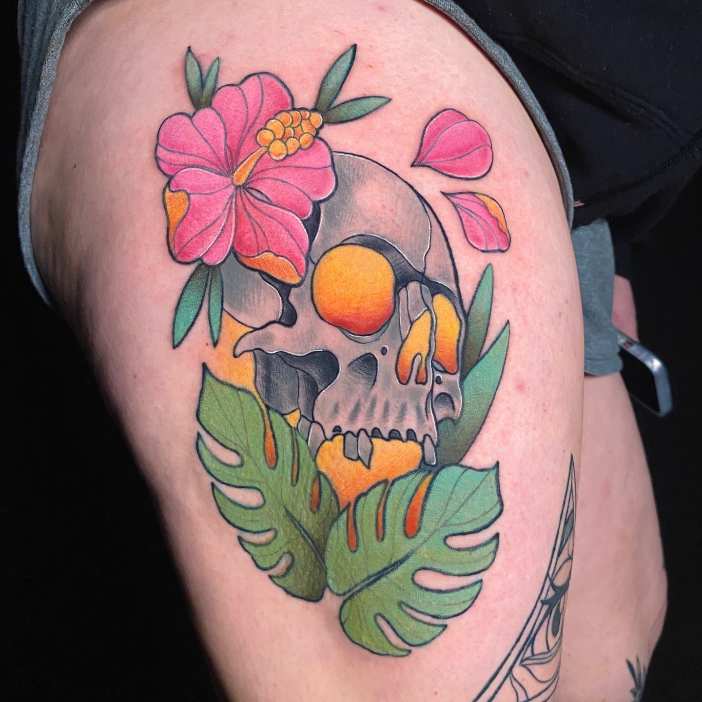 Skull with flowers American traditional tattoo on the thigh by Brian Overholt