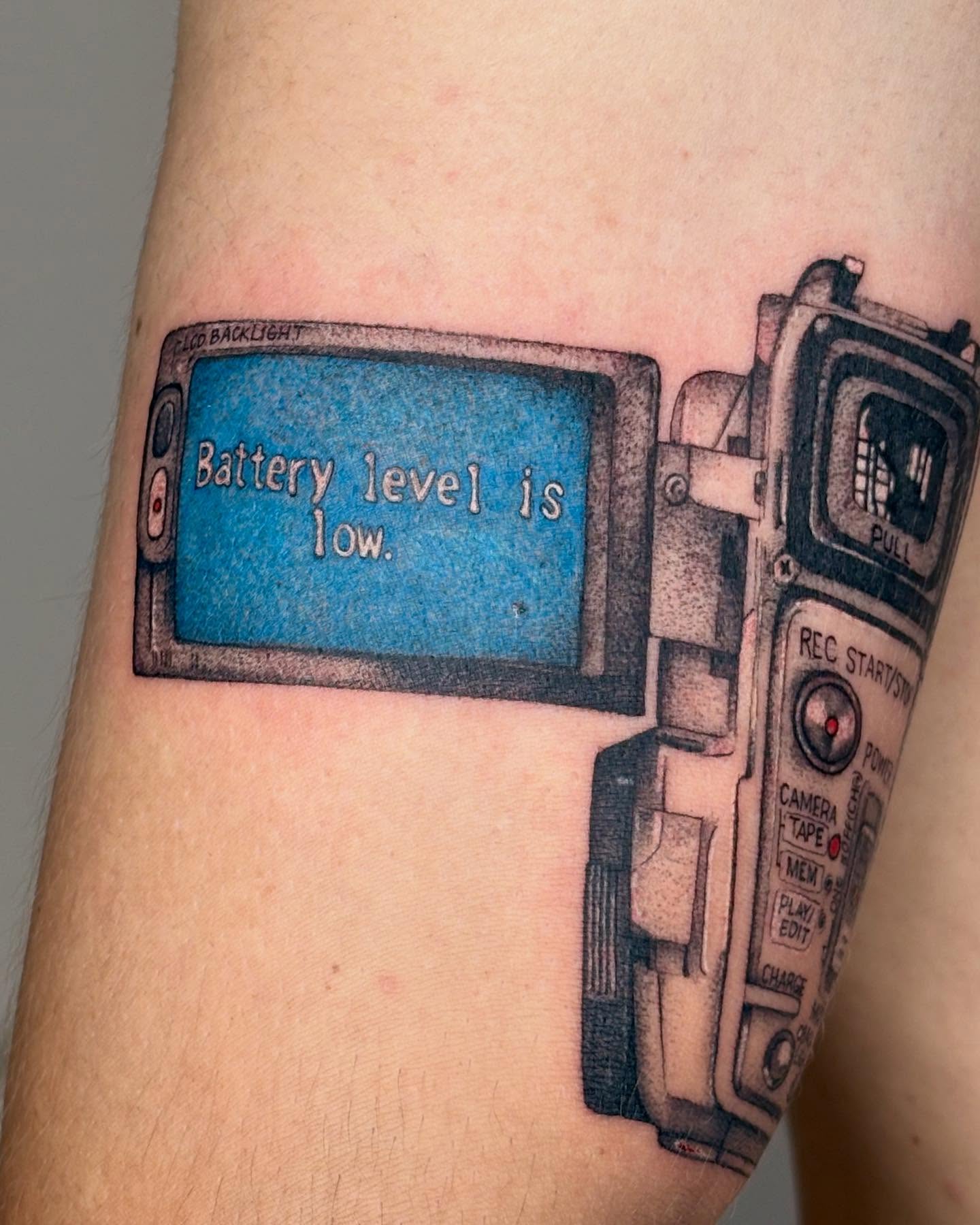 Camera with low battery realism tattoo on the forearm by β±βΏβ° π π π° π πΎ β±βΏβ°