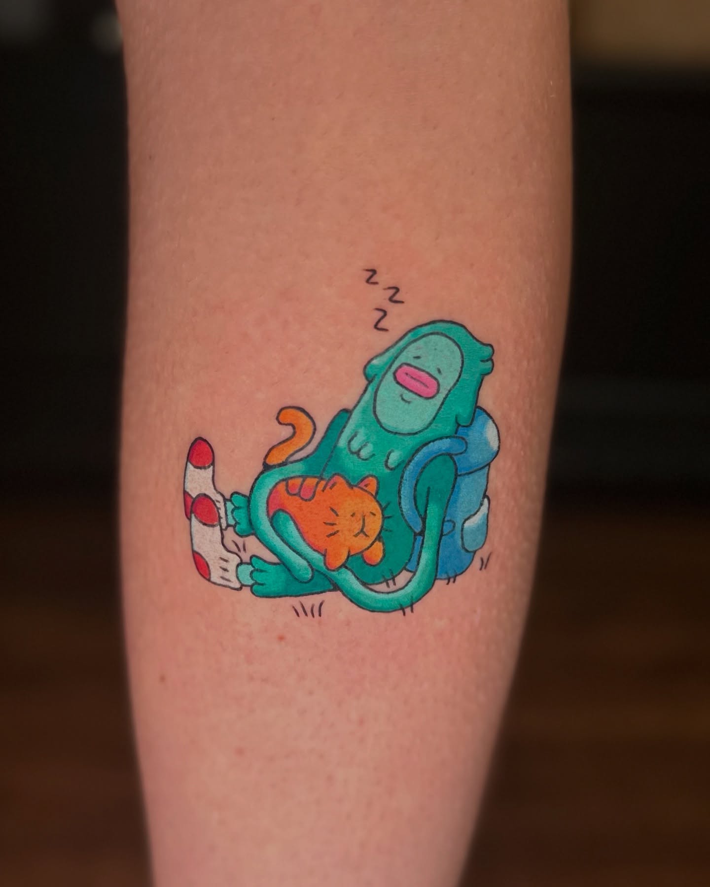 Cat and alien illustrative tattoo on the forearm by Kellie Burch