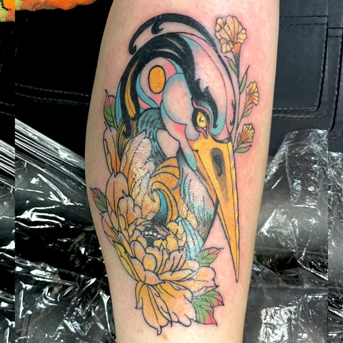 Bird and flowers new school tattoo on the forearm by Deville Pinson