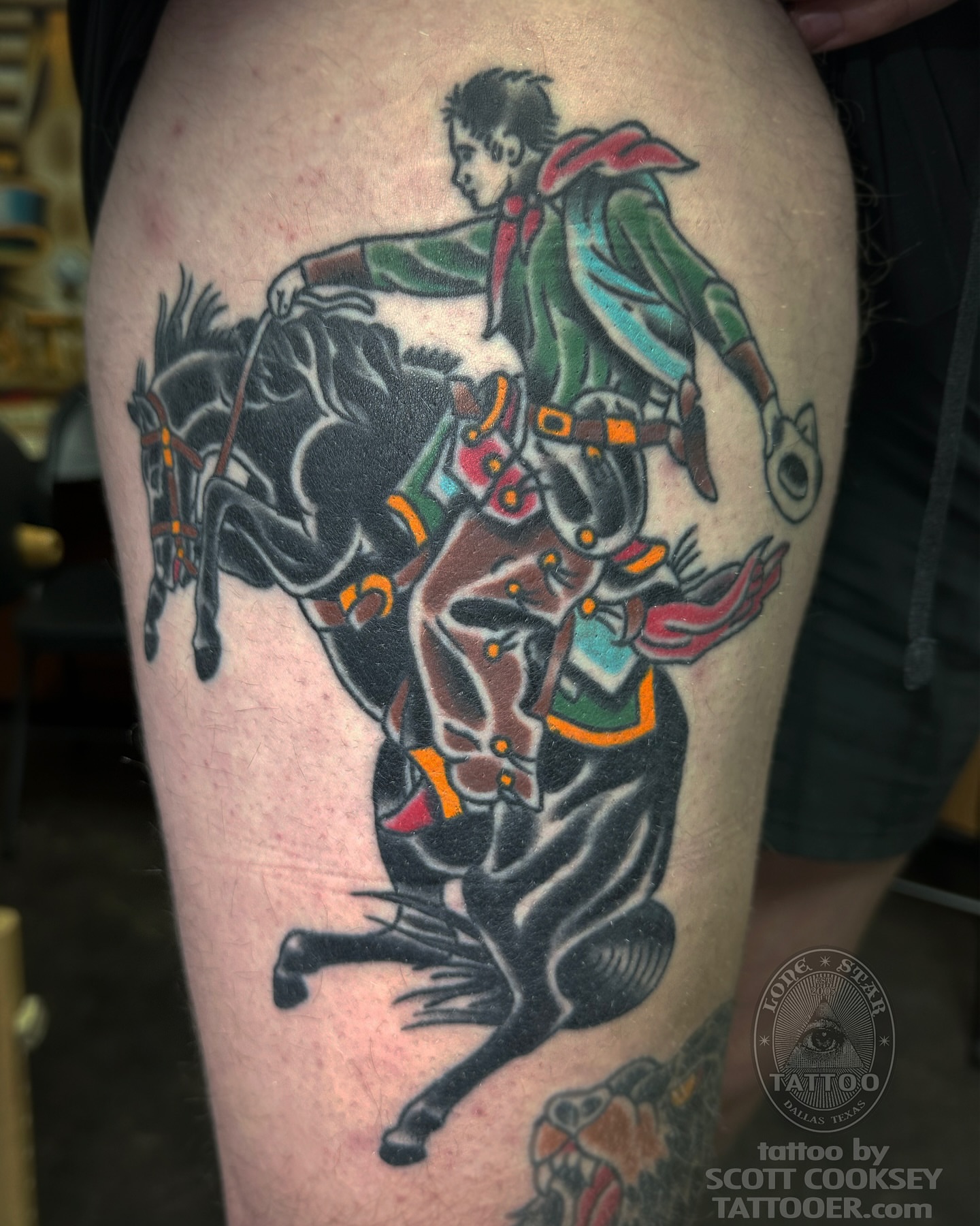 Cowboy riding horse American traditional tattoo on the thigh by Scott Allen Cooksey, Plano, Texas