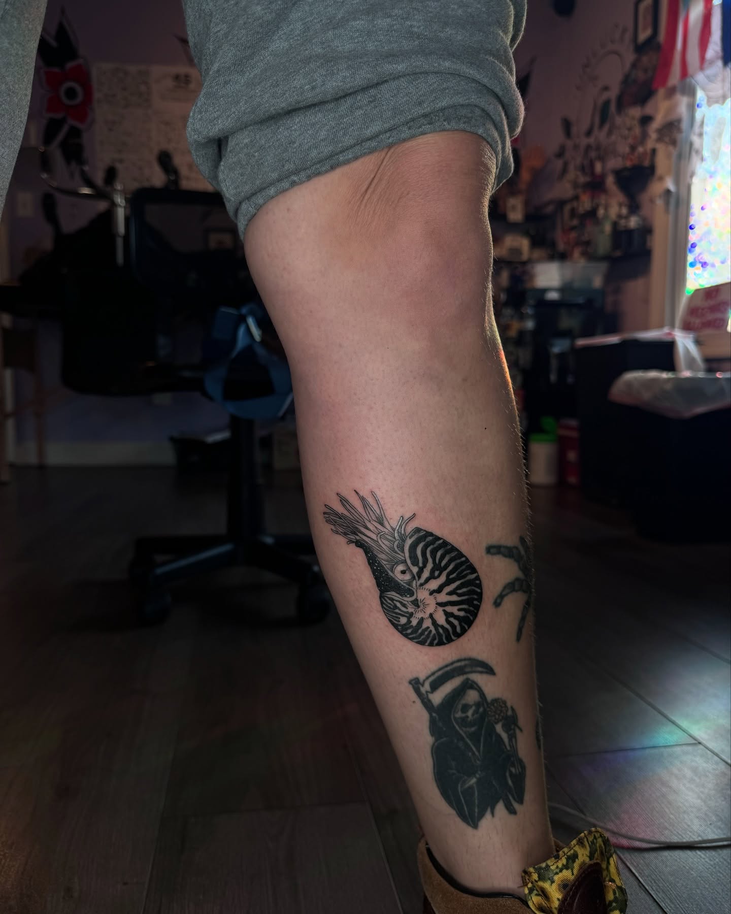 Nautilus shell and grim reaper realism tattoo on the forearm by Honey