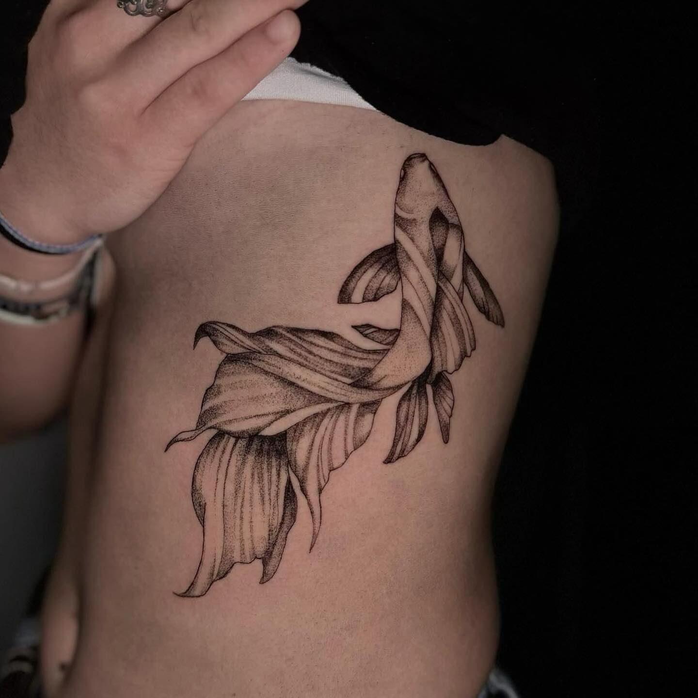 Fish black and grey tattoo on the ribs by V