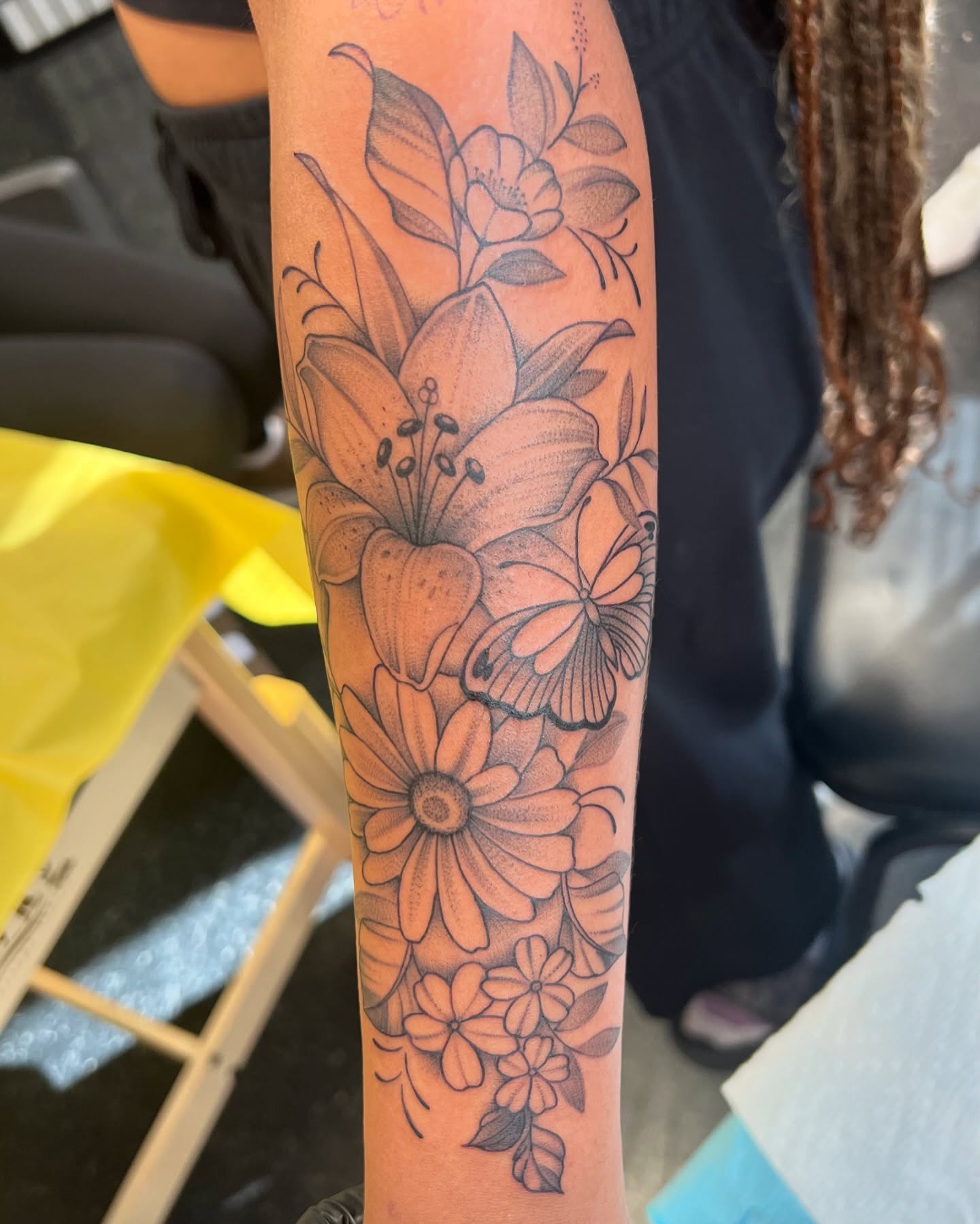 Flowers and butterfly dotwork tattoo on the forearm by Baung Ben