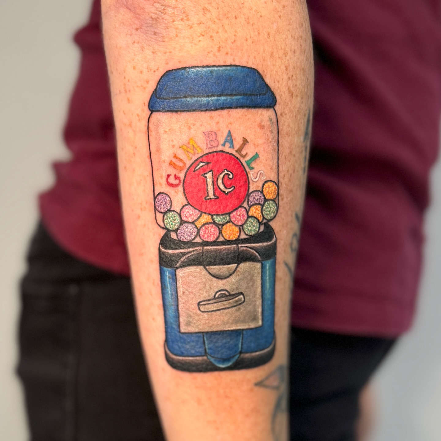 Gumball machine realism tattoo on the forearm by Ashley Rose - Minnesota Tattoo Artist