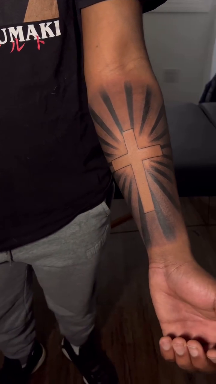 Cross with sunburst geometric tattoo by Jaiden Ducoff